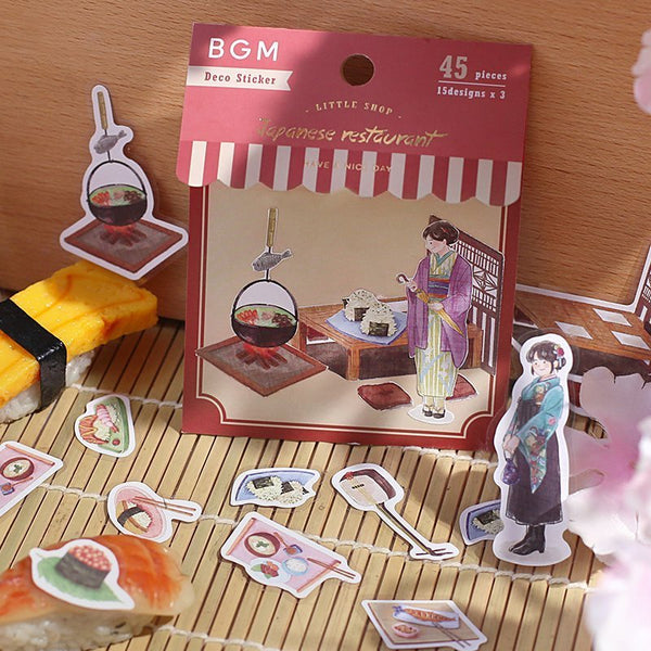 Serier - Little shop - Förpackning med klistermärken. Stickers med sushi-motiv ligger utströsslat runt - Tidformera