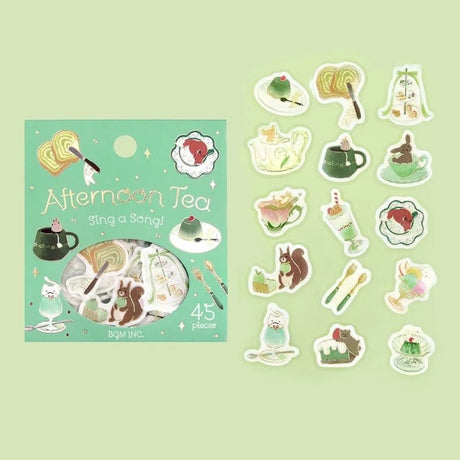 Flake stickers - Afternoon Tea Party - Sing a song från BGM. Förpackning med klistermärken. Bredvid ligger stickers med motiv med tekoppar, glas, efterrätter och djur. - Tidformera