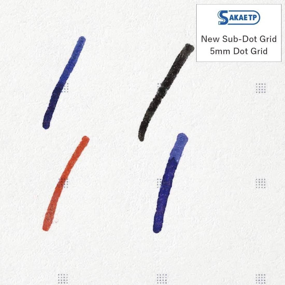 TomoeRiver Notebook softcover - A5 - Dot Grid från Sakae TP. Ett papper med fyra streck ritade på. - Tidformera