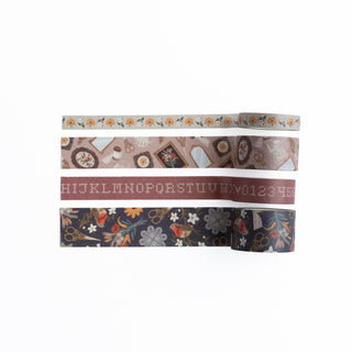 Fyra rullar dekorationstejp Àr utrullade. Motiv med blommor, fÄglar, saxar, tavlor och alfabetet.  Washi tape - Frame Wall - 4-pack - frÄn Archer & Olive - Tidformera