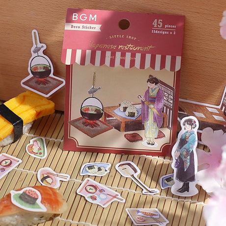 Serier - Little shop - Förpackning med klistermärken. Stickers med sushi-motiv ligger utströsslat runt - Tidformera