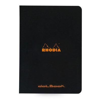 Serier - Skrivhäfte Rhodia - Svart skrivhäfte mot vit bakgrund. På skrivhäftet står det Rhodia i orange färg. - Tidformera